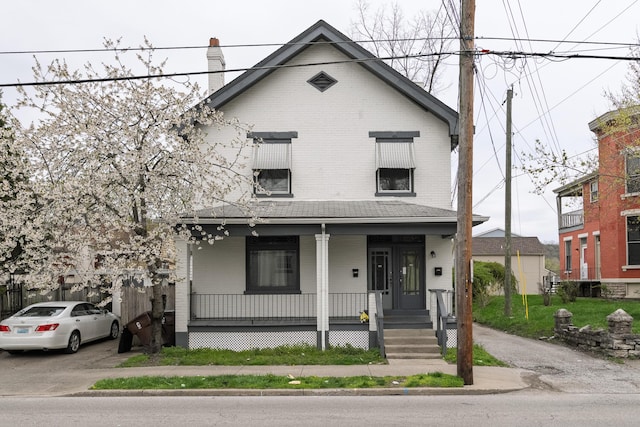 1706 Eastern Ave, Covington, KY 41014 - view of front of property featuring a porch, brick siding, and a chimney