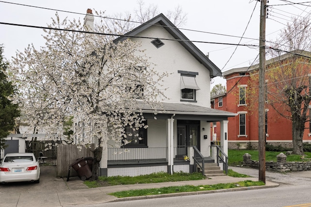 1706 Eastern Ave, Covington, KY 41014 - view of front facade with a porch, brick siding, and a chimney