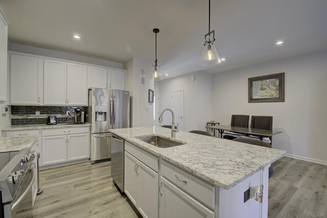 714 Streamside Dr Unit L, Alexandria, KY 41001 - kitchen with visible vents, a sink, light wood-type flooring, white cabinetry, and stainless steel appliances