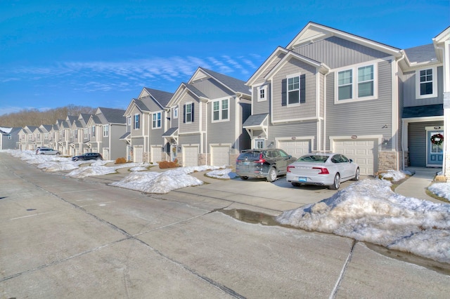 714 Streamside Dr Unit L, Alexandria, KY 41001 - view of front of property featuring driveway, stone siding, a residential view, and a garage