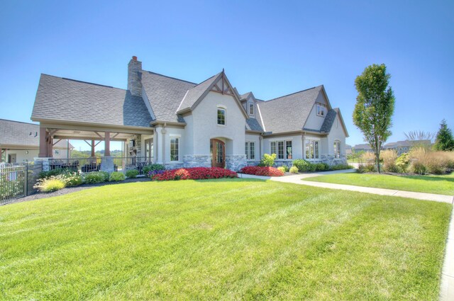 714 Streamside Dr Unit L, Alexandria, KY 41001 - french country home featuring stucco siding, stone siding, fence, a front lawn, and a chimney