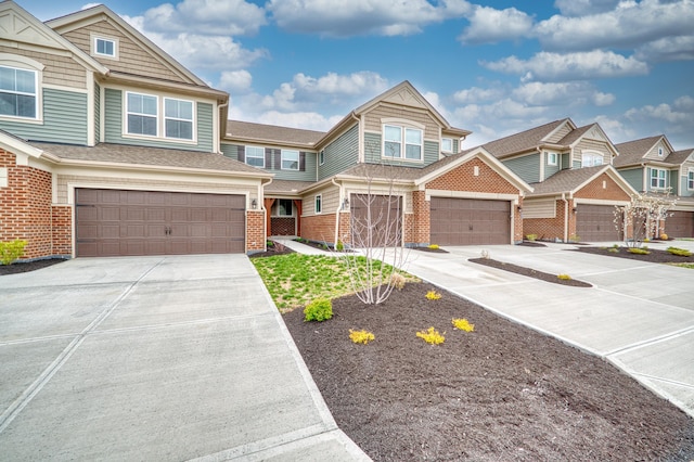 view of front of property with driveway, a garage, and brick siding
