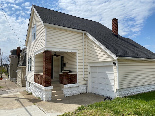 view of front of home featuring aphalt driveway, roof with shingles, brick siding, an attached garage, and a chimney