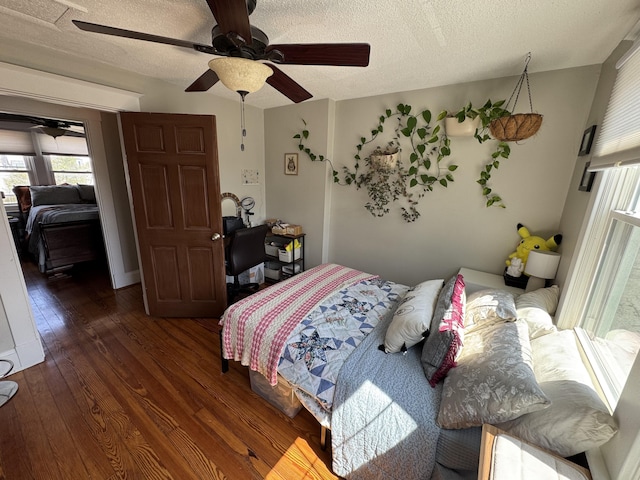 bedroom featuring hardwood / wood-style flooring, a textured ceiling, and ceiling fan