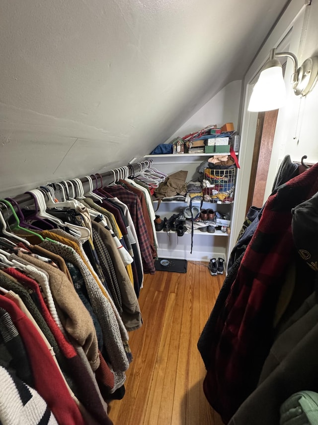 spacious closet featuring wood-type flooring and vaulted ceiling