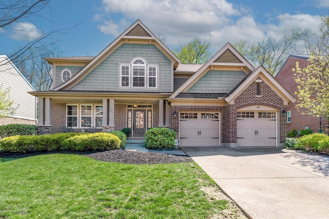 craftsman-style home with an attached garage, driveway, a front yard, and brick siding