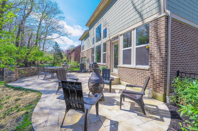 view of patio featuring outdoor dining area and an outdoor fire pit