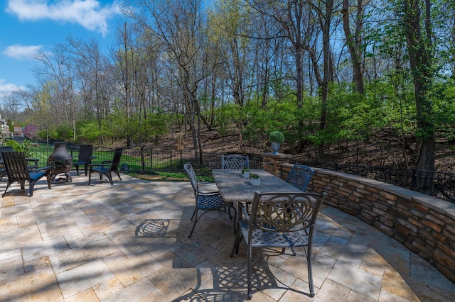 view of patio with fence and outdoor dining area