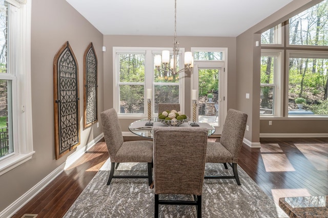 sunroom / solarium with a notable chandelier