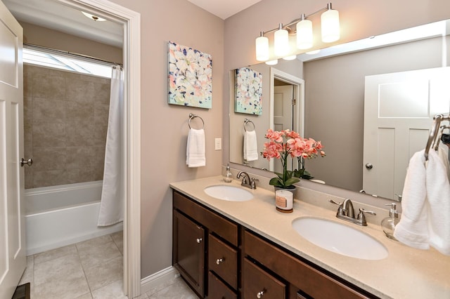bathroom featuring double vanity, a sink, tile patterned flooring, and visible vents