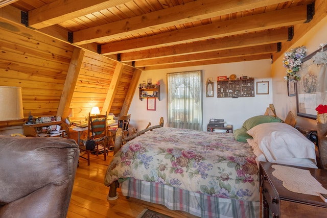 bedroom with beamed ceiling, wood-type flooring, and wooden ceiling