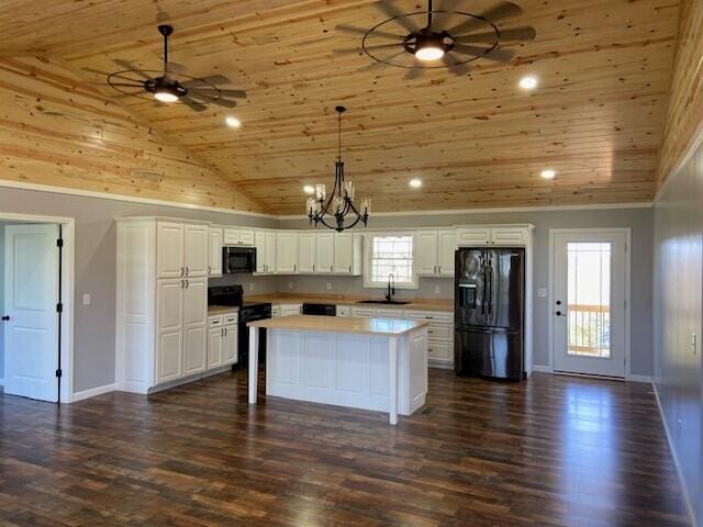 kitchen featuring a sink, black appliances, wooden ceiling, and ceiling fan with notable chandelier