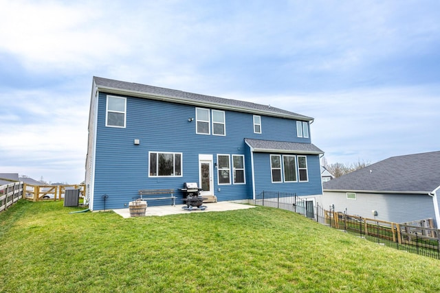 back of property with a patio, a yard, fence, and central AC unit