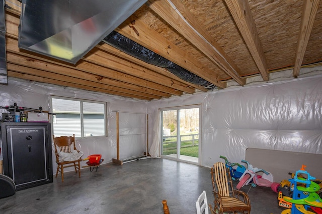 rec room featuring finished concrete flooring and a healthy amount of sunlight