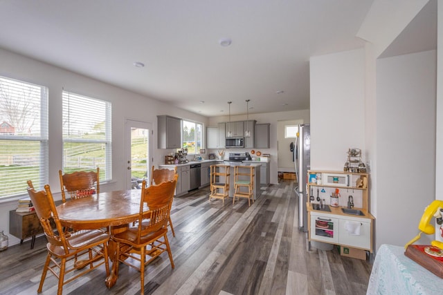 dining space with dark wood-type flooring