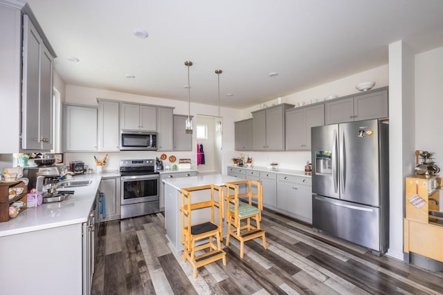 kitchen with stainless steel appliances, light countertops, and gray cabinets