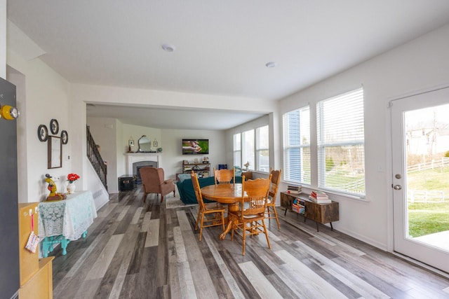 dining area with a fireplace and wood finished floors