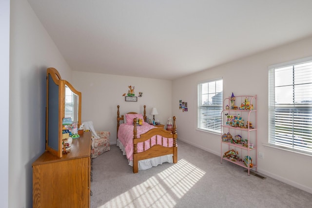 carpeted bedroom featuring baseboards