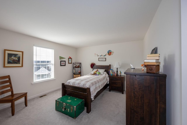 bedroom with visible vents, baseboards, and light colored carpet