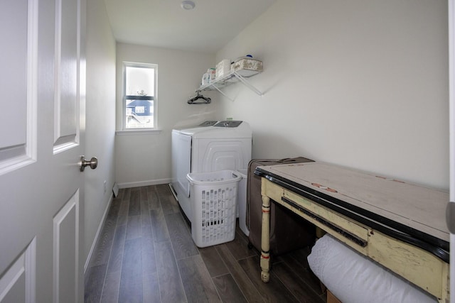 laundry room with dark wood-type flooring, baseboards, separate washer and dryer, and laundry area