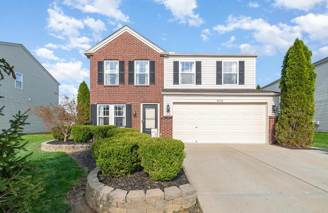 traditional home with brick siding, an attached garage, and driveway