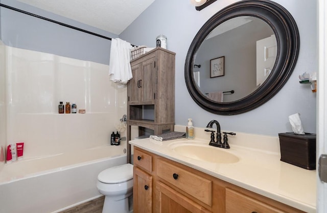 full bathroom with toilet, wood finished floors, vanity, and shower / washtub combination