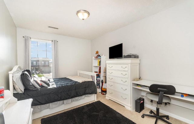bedroom with visible vents and light carpet