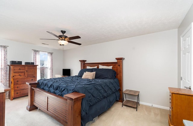 bedroom featuring light carpet, baseboards, and a ceiling fan