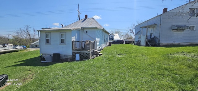 rear view of property featuring a lawn