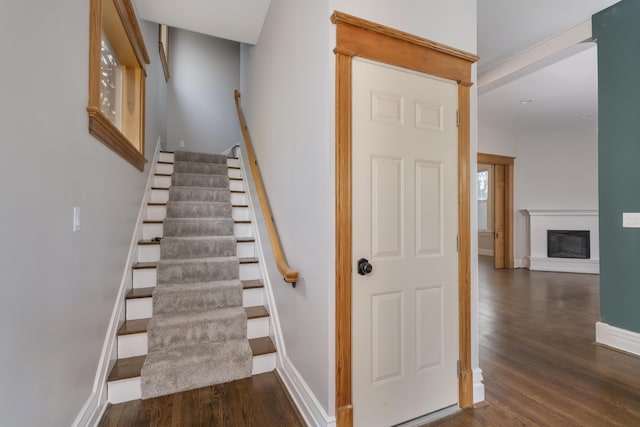 224 Wallace Ave, Covington, KY 41014 - stairs featuring baseboards, a glass covered fireplace, and wood finished floors