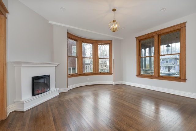 224 Wallace Ave, Covington, KY 41014 - unfurnished living room with a glass covered fireplace, baseboards, dark wood-style floors, and a chandelier