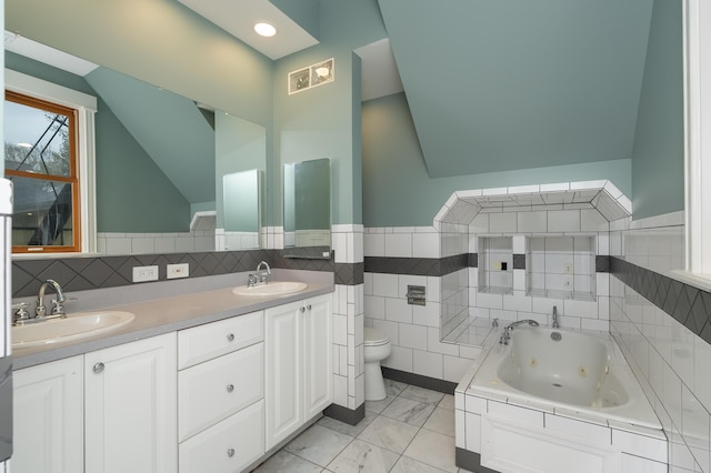 224 Wallace Ave, Covington, KY 41014 - bathroom featuring vaulted ceiling, tile walls, toilet, and a sink