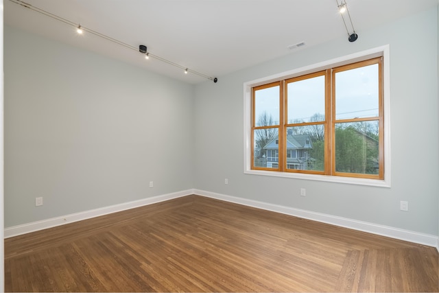 224 Wallace Ave, Covington, KY 41014 - unfurnished room featuring rail lighting, baseboards, dark wood-type flooring, and visible vents
