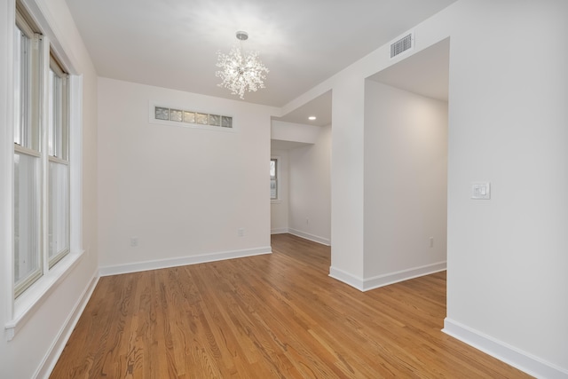 224 Wallace Ave, Covington, KY 41014 - unfurnished room featuring baseboards, a notable chandelier, light wood finished floors, and visible vents