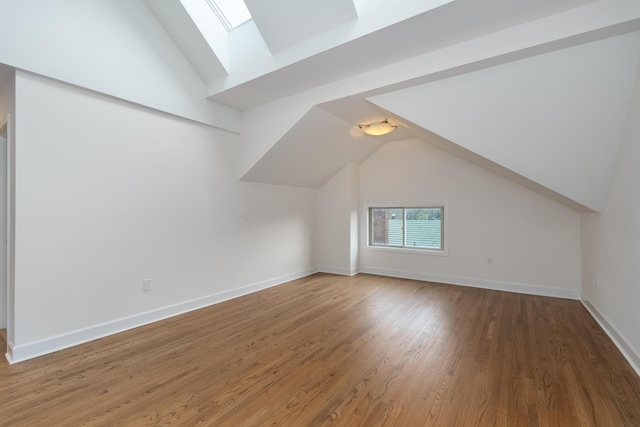 224 Wallace Ave, Covington, KY 41014 - bonus room featuring baseboards, wood finished floors, and lofted ceiling with skylight