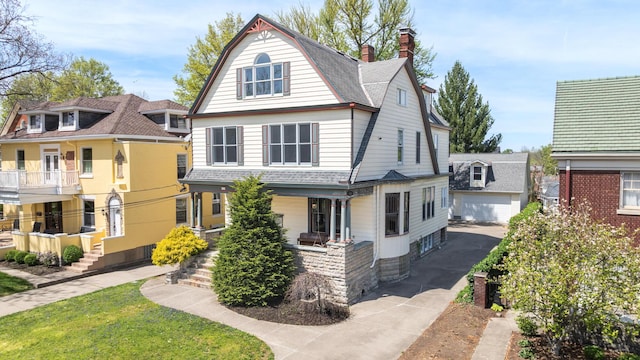 224 Wallace Ave, Covington, KY 41014 - view of front of house featuring a chimney, an outdoor structure, aphalt driveway, a gambrel roof, and a detached garage