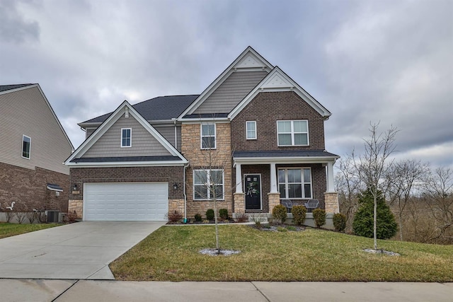 craftsman-style home with a front yard, an attached garage, stone siding, concrete driveway, and central air condition unit