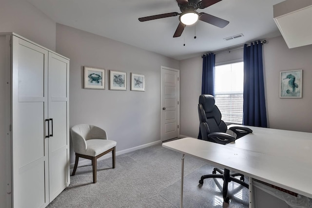 office area with light carpet, baseboards, a ceiling fan, and visible vents