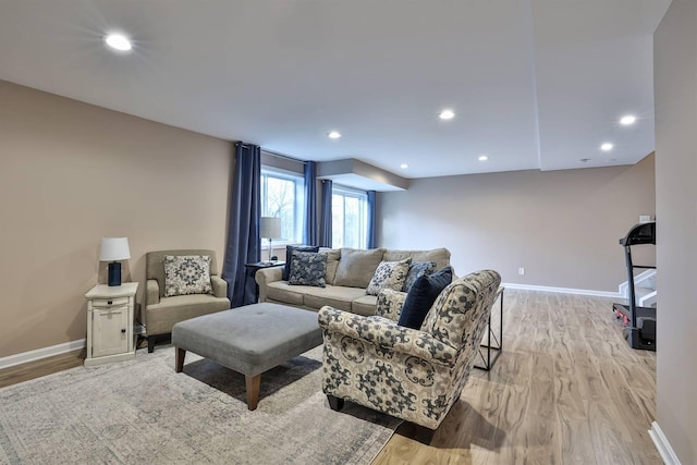 living room with recessed lighting, light wood-style flooring, and baseboards