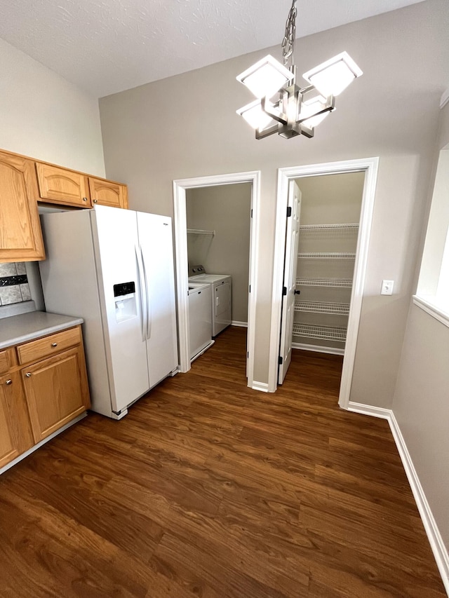 kitchen with separate washer and dryer, a notable chandelier, light countertops, dark wood finished floors, and white refrigerator with ice dispenser