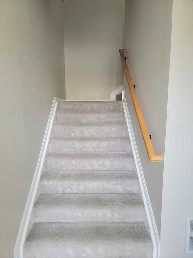 stairway featuring visible vents