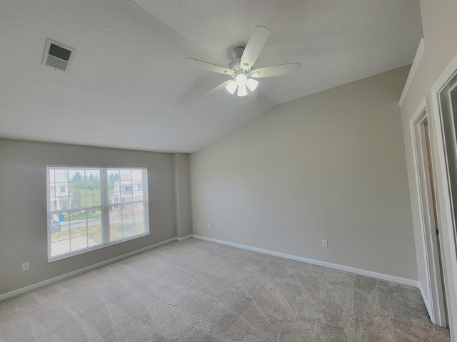 unfurnished room with ceiling fan, carpet, visible vents, lofted ceiling, and baseboards