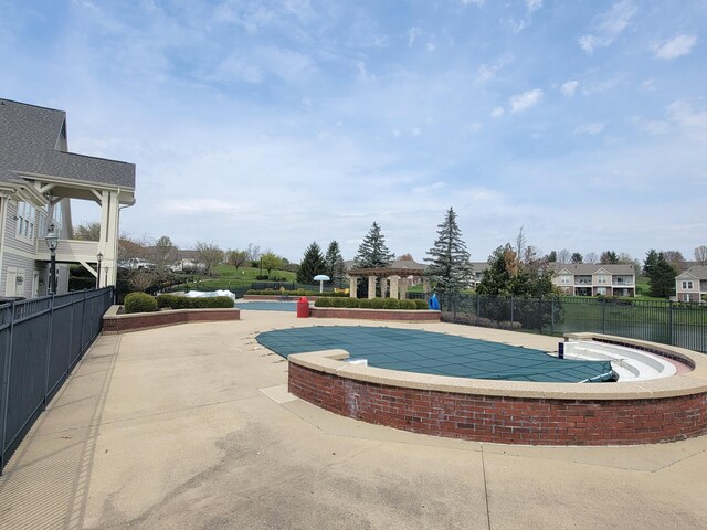 view of community with a patio area, fence, and a pool