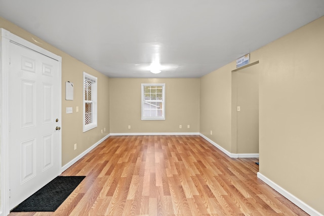foyer entrance with light wood-type flooring and baseboards
