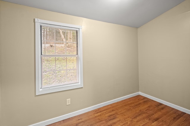 empty room with wood finished floors and baseboards