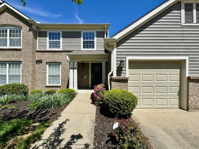 view of front of property featuring brick siding and driveway