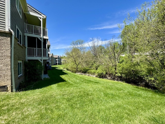 view of yard featuring a balcony