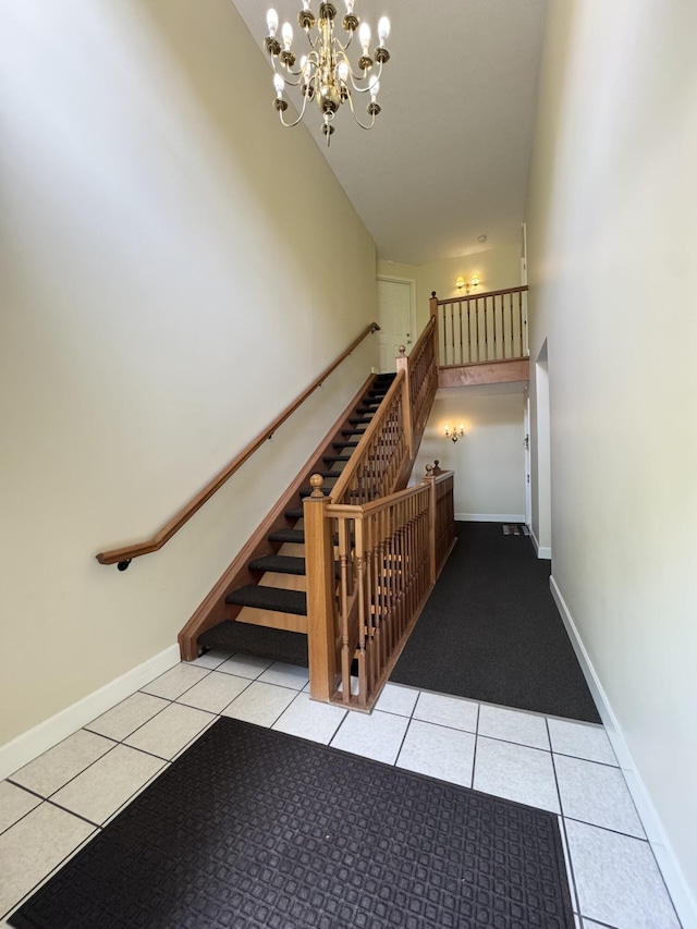 stairway with tile patterned floors, a chandelier, and baseboards