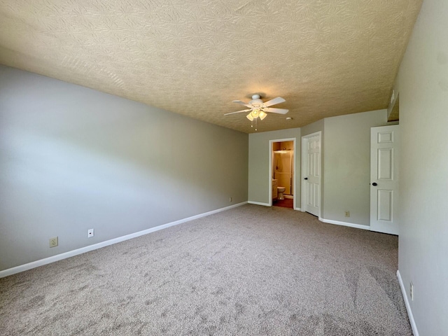 empty room with baseboards, ceiling fan, and carpet