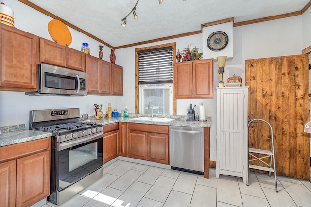 1028 Orchard St, Newport, KY 41071 - kitchen featuring stainless steel appliances, brown cabinets, a sink, and crown molding